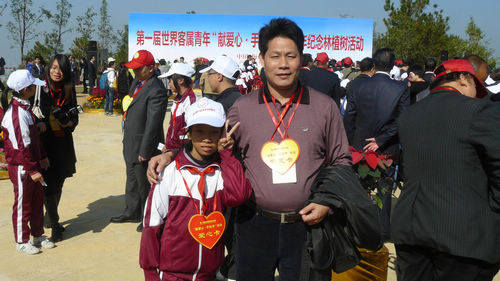 東源縣客屬青年代表與貧困學(xué)生交換愛(ài)心卡、感恩卡。